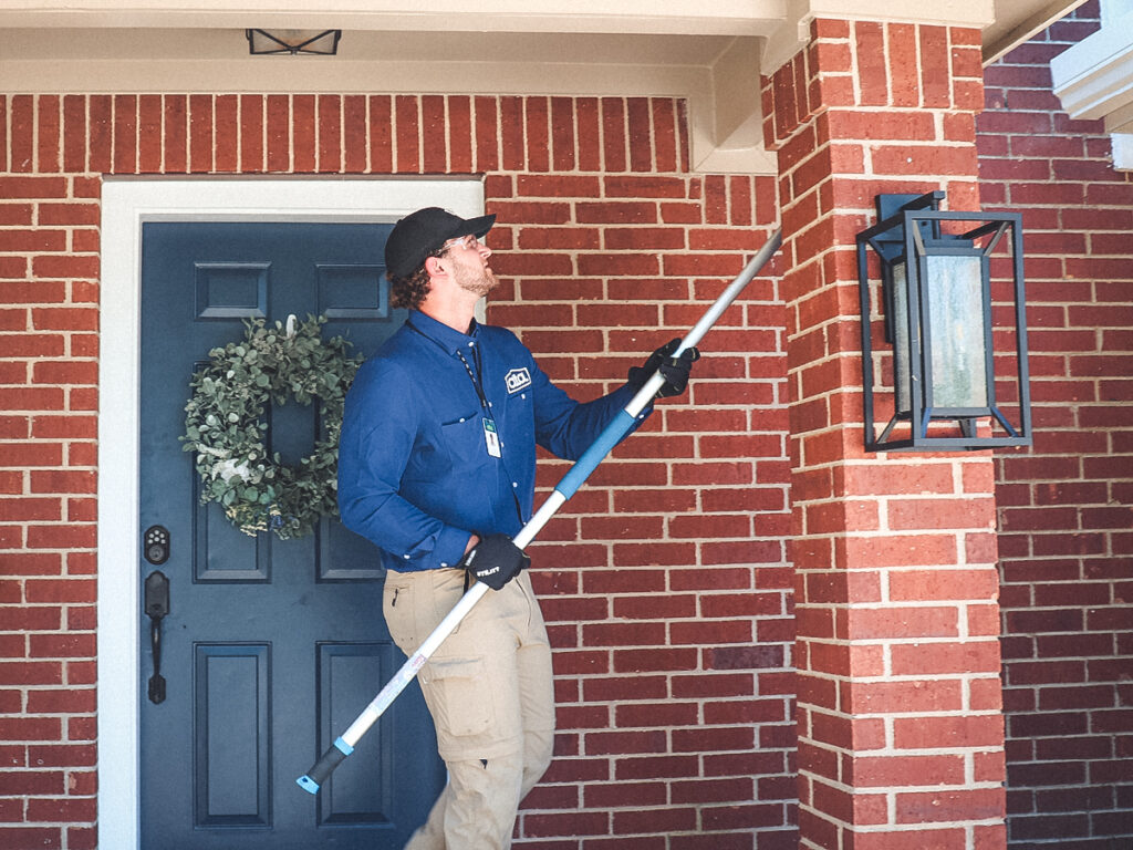 Alta Pest Control tech getting rid of dirt dauber nests